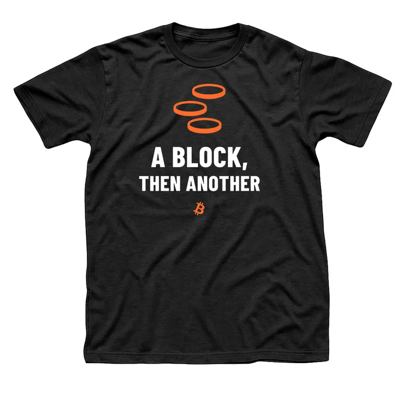 Black t-shirt with three orange stepping stones above A Block, Then Another in white capitals and a small orange Bitcoin symbol below