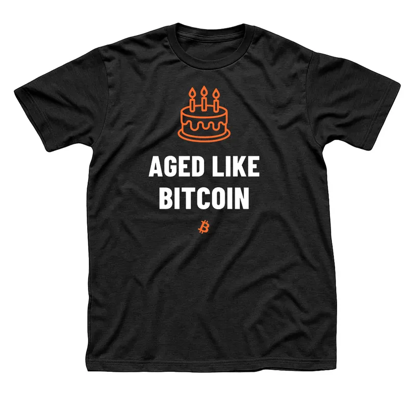 Black t-shirt with an orange birthday cake with three lit candles above Aged Like Bitcoin in white