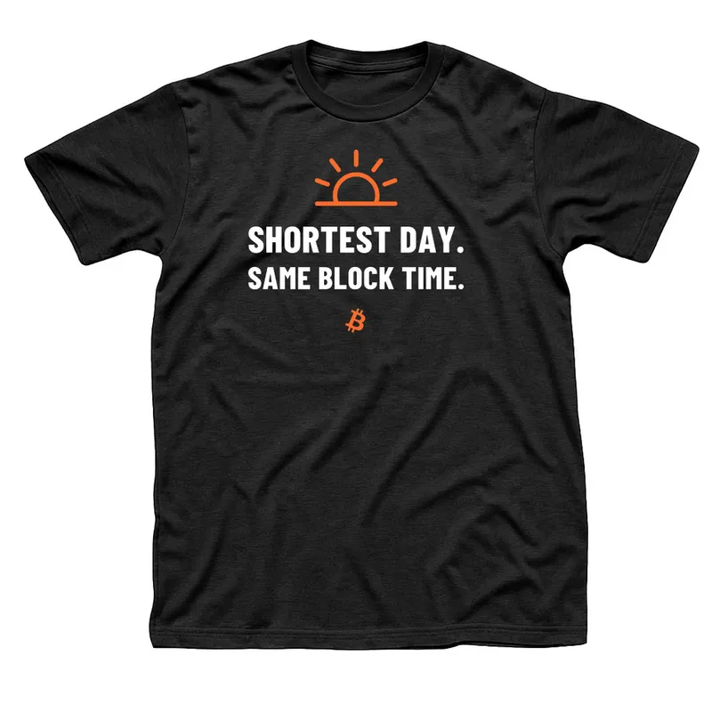 Black t-shirt with an orange half sun on a horizon above Shortest Day, Same Block Time in white capitals and a small orange Bitcoin symbol below